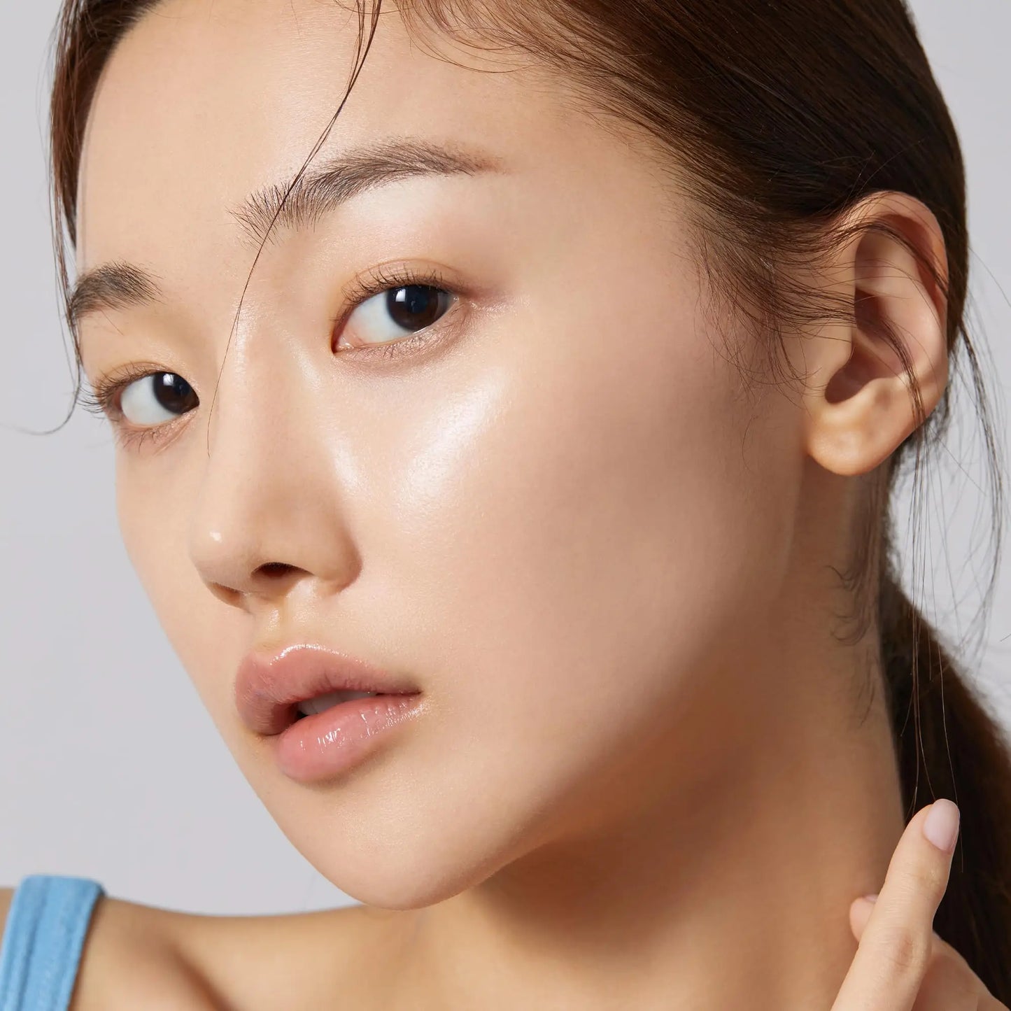 Close-up portrait of a woman with clear, glowing skin demonstrating the effects of medicube Zero Foam Cleanser 120g for radiant and hydrated facial care.