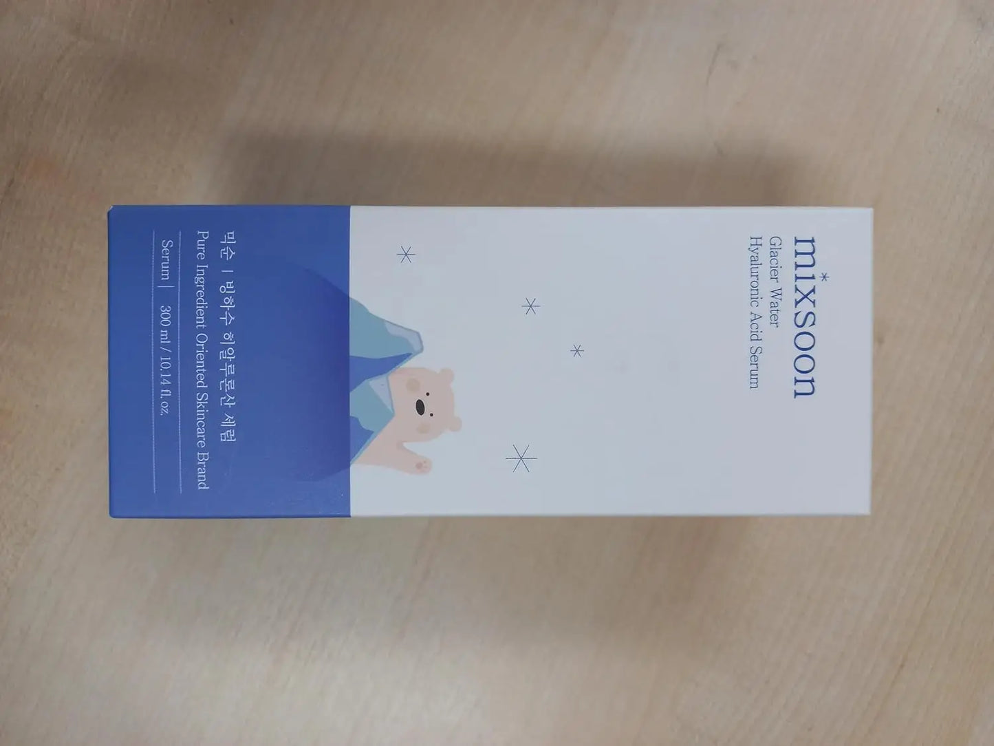 Mixsoon Glacier Water Hyaluronic Acid Serum 300ml packaging with a blue and white design featuring a small bear illustration and product details.