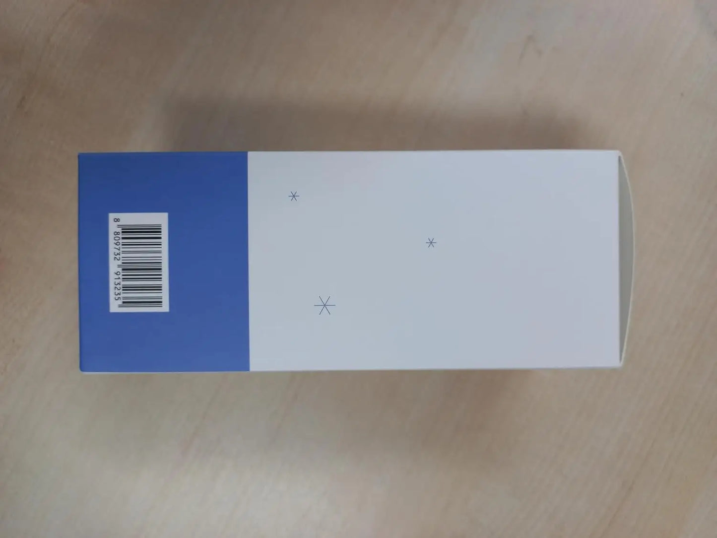 Box packaging for Mixsoon Glacier Water Hyaluronic Acid Serum 300ml featuring a minimalistic white and blue design with small snowflake-like icons on a wooden surface.