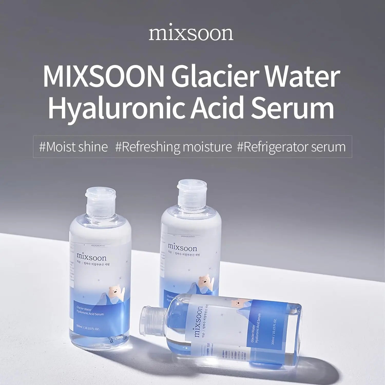 Three clear bottles of Mixsoon Glacier Water Hyaluronic Acid Serum 300ml with blue labels featuring a polar bear design, displayed on a light surface with soft shadows and text highlighting moisture benefits.