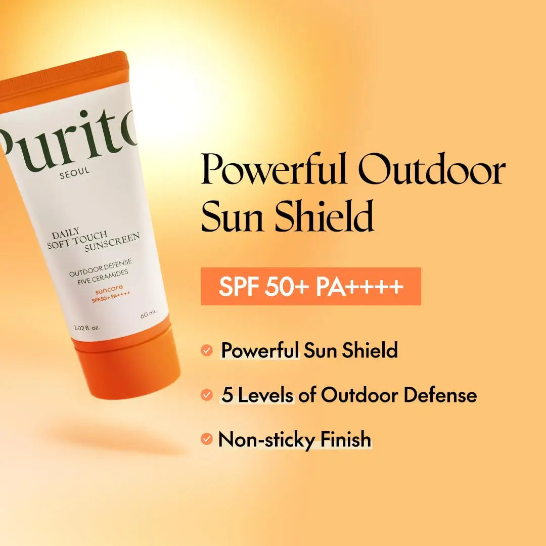 Tube of PURITO Daily Soft Touch Sunscreen with SPF 50+ PA++++ on warm orange background highlighting powerful sun shield, 5 levels of outdoor defense, and non-sticky finish.