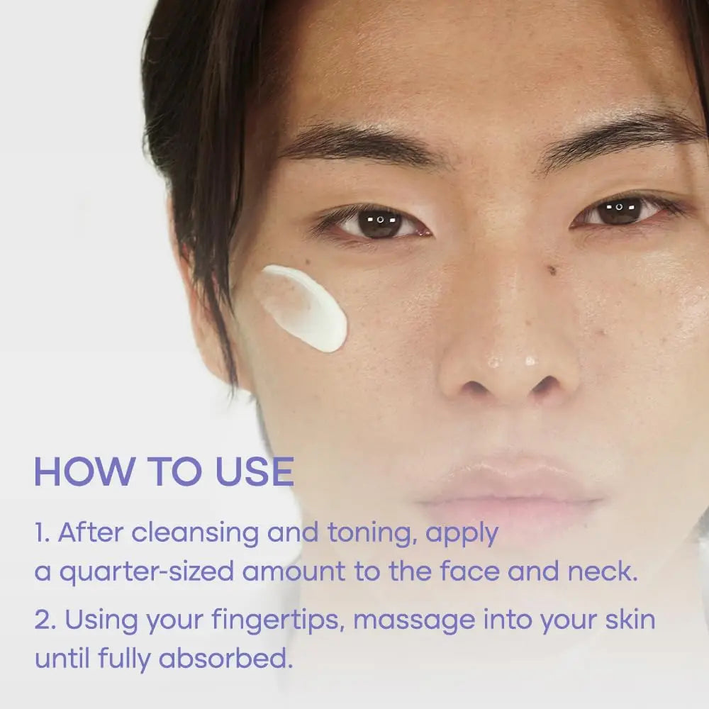 Close-up of a person with a dollop of white cream on their cheek demonstrating how to apply PURITO Dermide Cica Barrier Sleeping Pack 80ml by gently massaging a quarter-sized amount onto the face and neck after cleansing and toning.