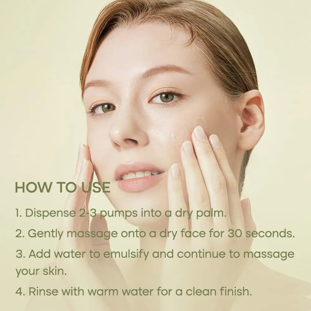 Close-up of a woman gently applying PURITO From Green Cleansing Oil 200ml on her face with clear instructions on how to use the product for effective cleansing.