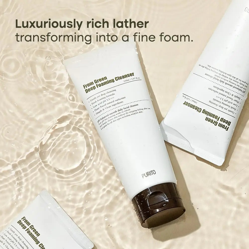 Three tubes of PURITO From Green Deep Foaming Cleanser 150ml submerged in water with ripples, showcasing smooth white packaging and text highlighting luxurious rich lather transforming into fine foam.