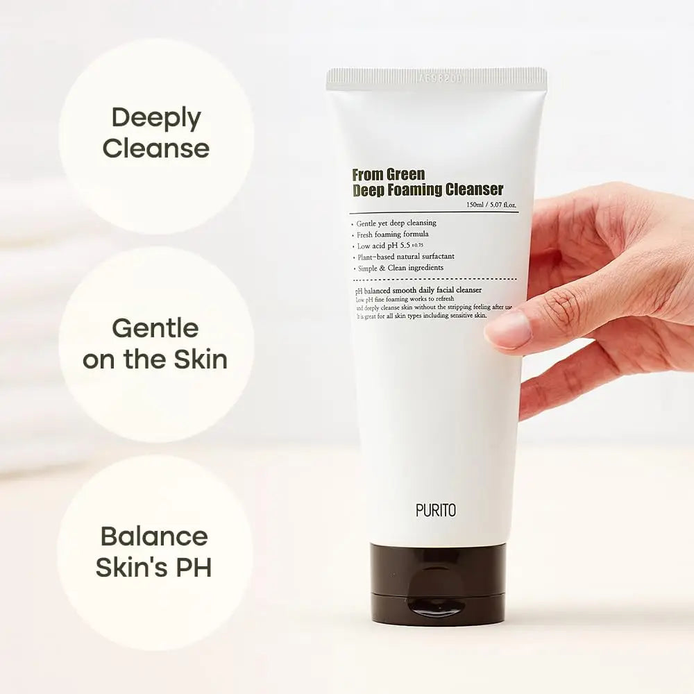 Hand holding a white tube of PURITO From Green Deep Foaming Cleanser 150ml with text bubbles highlighting deeply cleanse, gentle on the skin, and balance skin's pH benefits