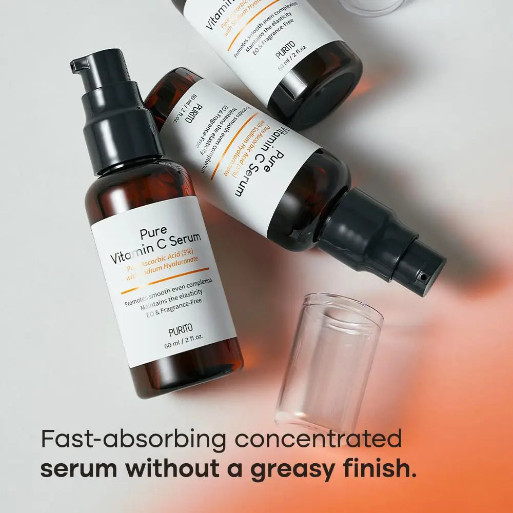 PURITO Pure Vitamin C Serum 60ml in amber bottles with pump caps, displayed on a light surface with text highlighting its fast-absorbing and non-greasy formula