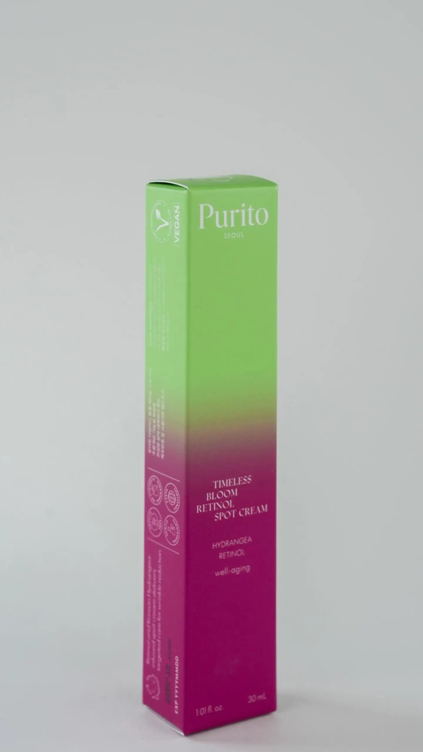 Box packaging of PURITO Timeless Bloom Retinol Spot Cream 30ml with green to pink gradient design and product details on a plain background.