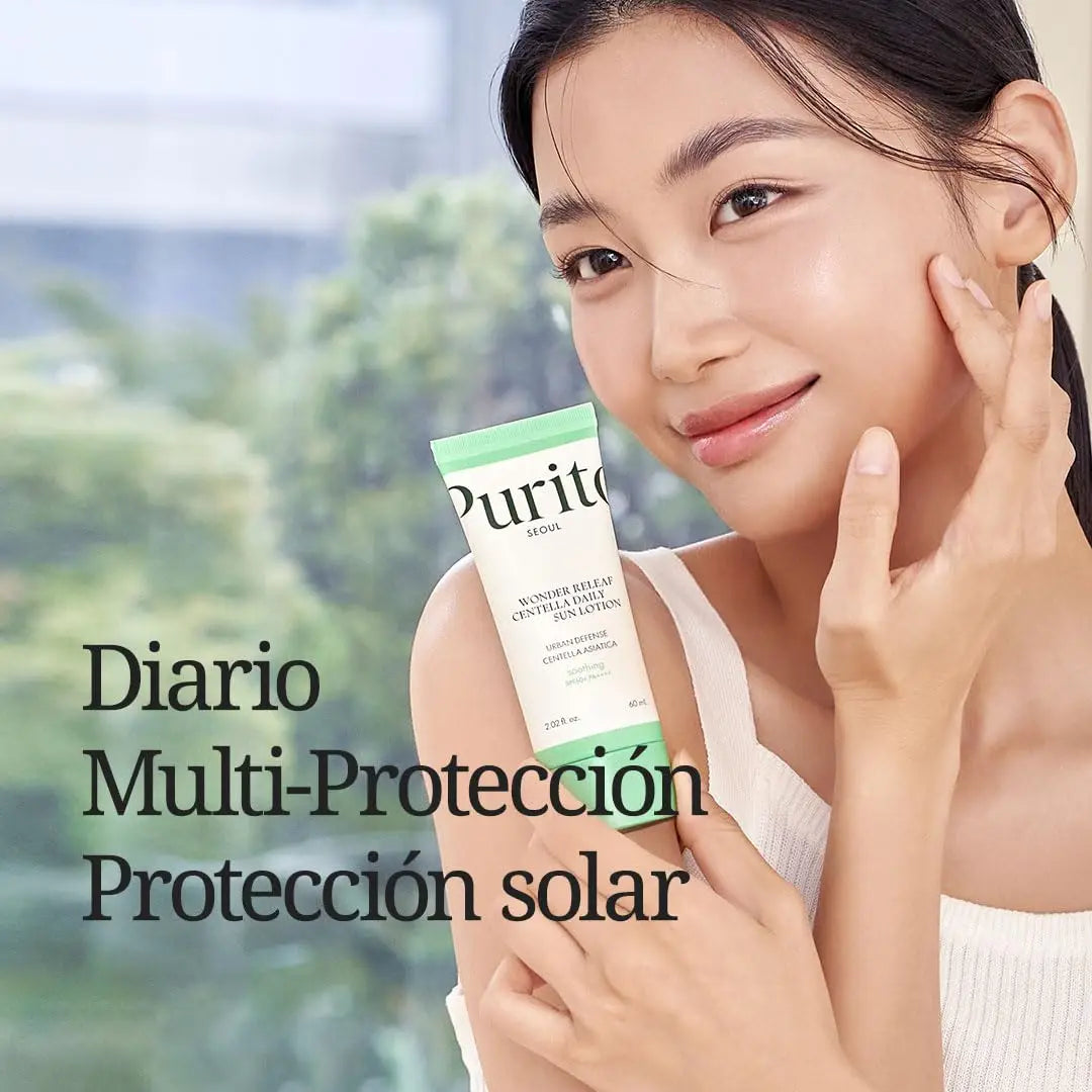 Young woman with glowing skin holding PURITO Wonder Releaf Centella Daily Sun Lotion tube, promoting daily multi-protection facial sunscreen for natural skincare.