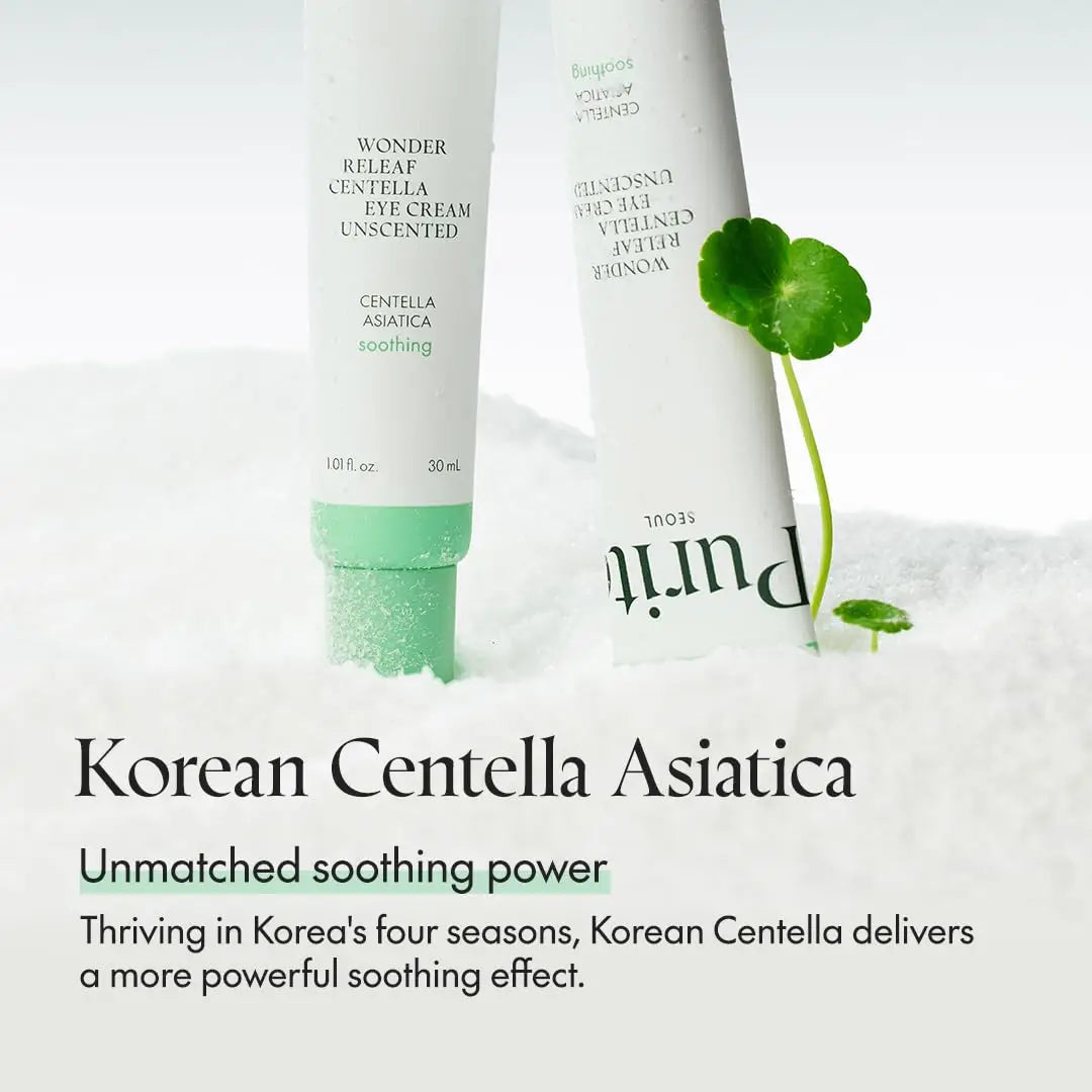 Two tubes of PURITO Wonder Releaf Centella Eye Cream Unscented 30ml standing in white textured surface with green centella asiatica leaves nearby, highlighting soothing skincare benefits.