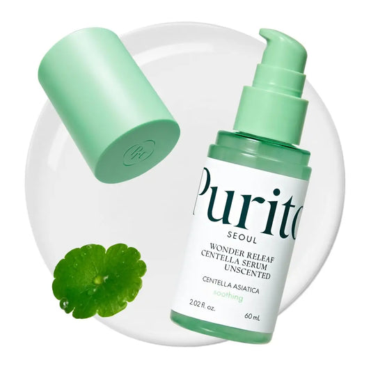 PURITO Wonder Releaf Centella Unscented Serum bottle with green pump and cap, placed on a white dish with a fresh centella leaf, highlighting the calming facial serum.