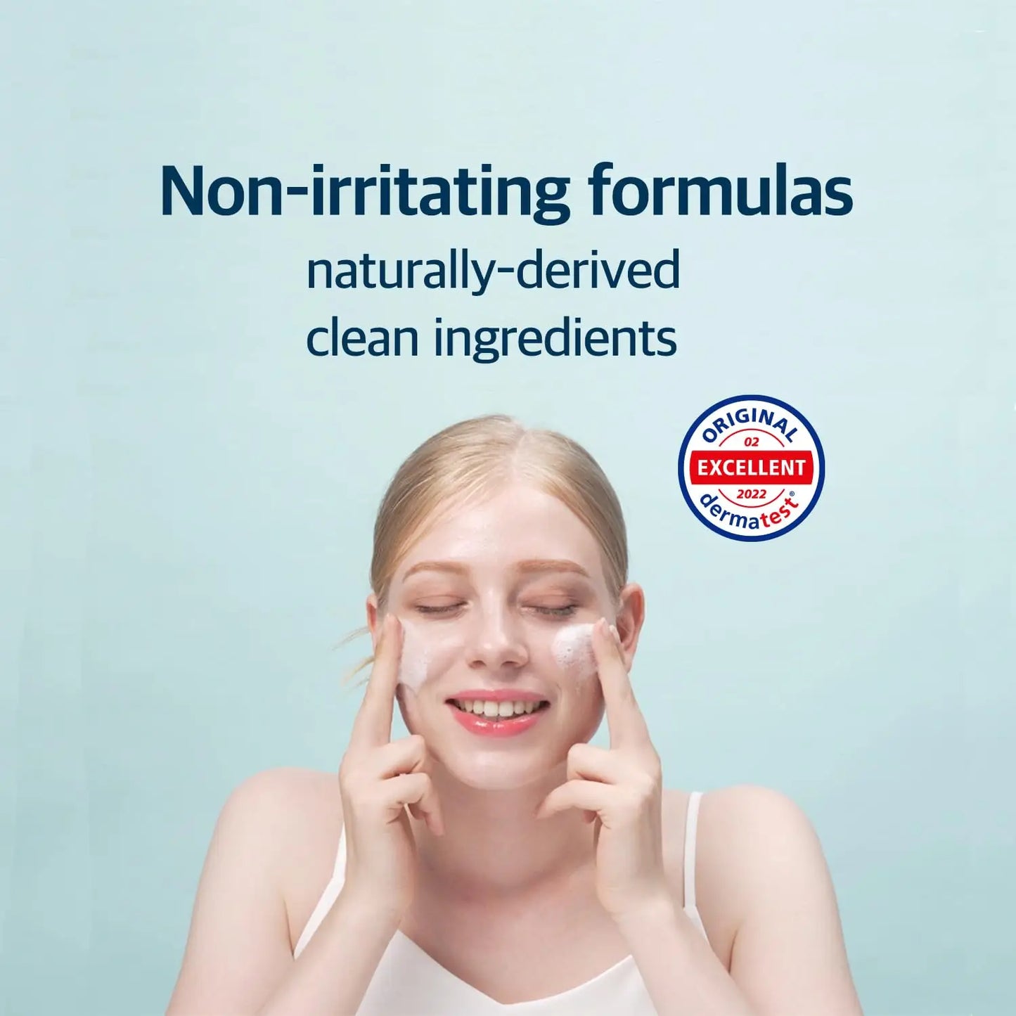 Woman with fair skin gently applying cleanser to her face with fingers under text promoting non-irritating formulas and naturally-derived clean ingredients, featuring ROUND LAB 1025 Dokdo Cleanser 150ml and a dermatologically tested seal.