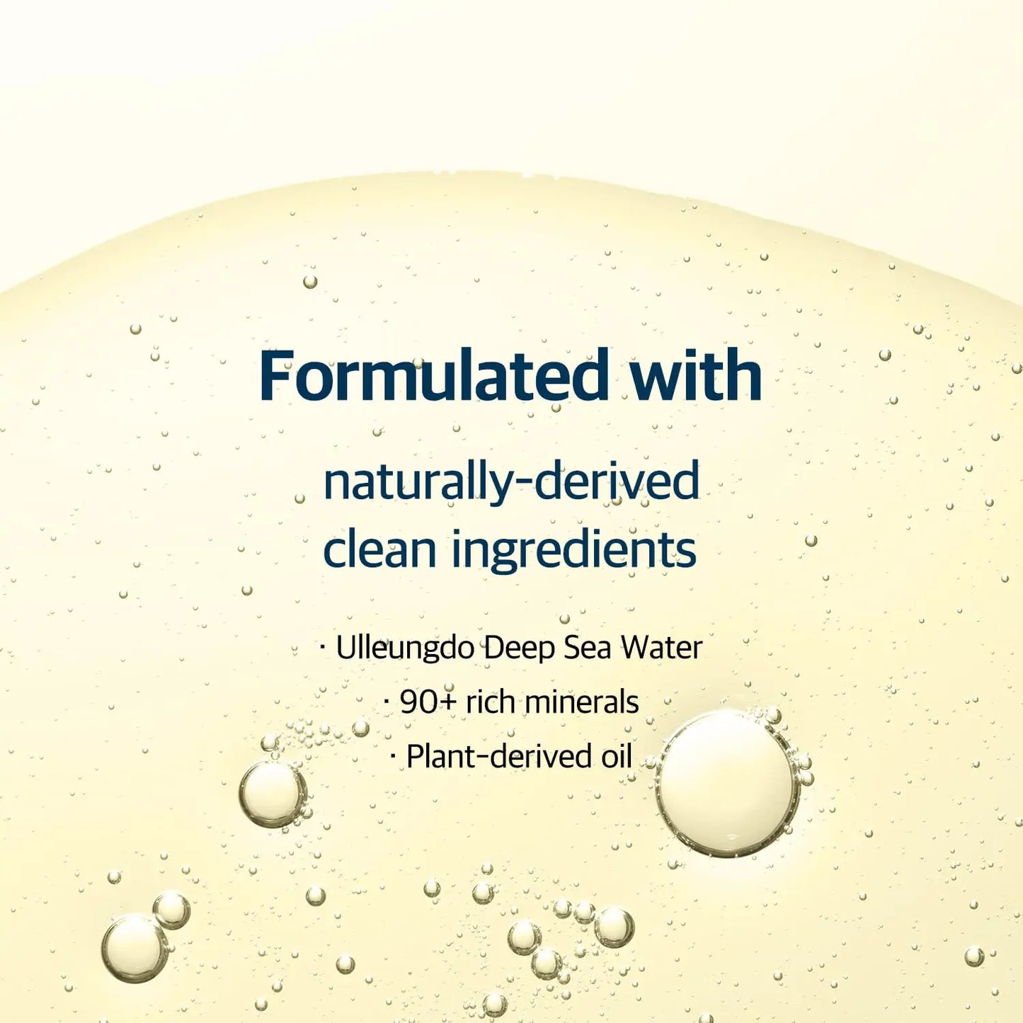 Close-up of a clear cleansing oil texture with bubbles, highlighting the formulation of ROUND LAB 1025 Dokdo Cleansing Oil 200ml with naturally-derived ingredients like Ulleungdo deep sea water, 90+ rich minerals, and plant-derived oil.