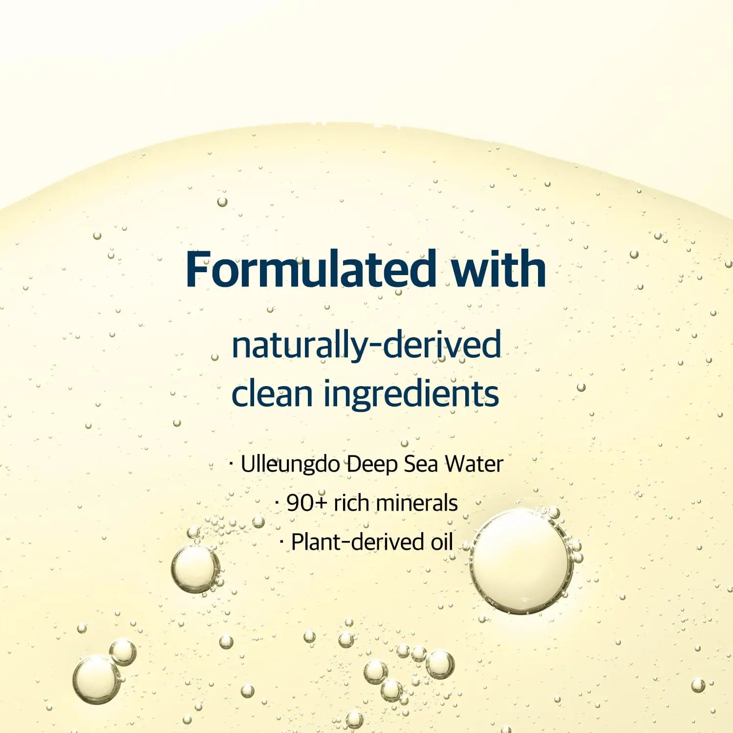 Close-up of a clear cleansing oil texture with bubbles, highlighting the formulation of ROUND LAB 1025 Dokdo Cleansing Oil 200ml with naturally-derived ingredients like Ulleungdo deep sea water, 90+ rich minerals, and plant-derived oil.