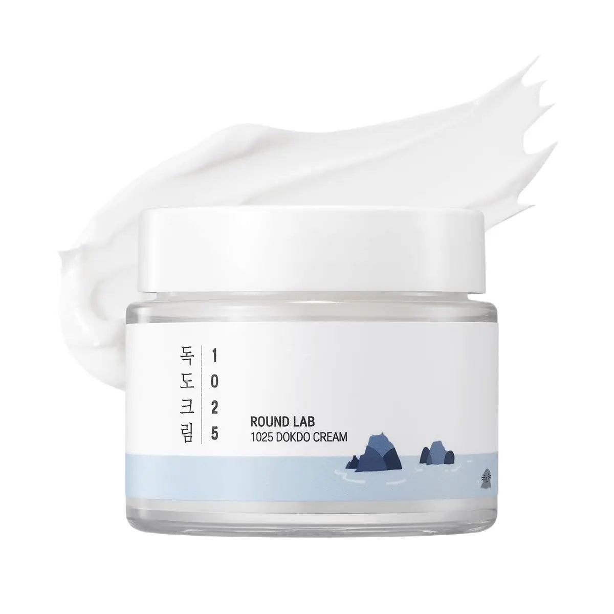 ROUND LAB 1025 DOKDO CREAM 80ml in a transparent jar with a white lid and blue ocean-inspired design, showing a smooth white cream texture behind it.