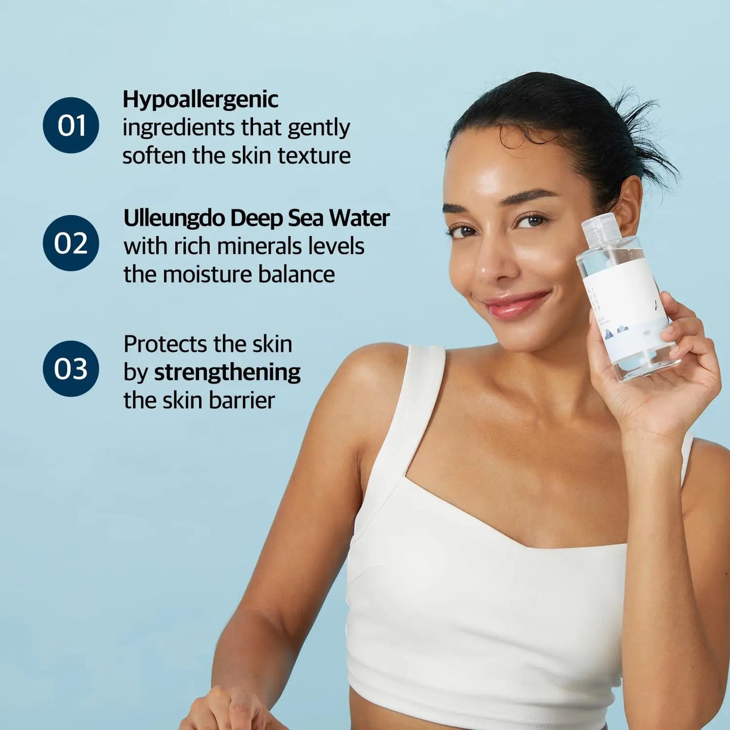 Woman smiling and holding a bottle of ROUND LAB 1025 Dokdo Toner 100ml with text highlighting hypoallergenic ingredients, Ulleungdo Deep Sea Water, and skin barrier protection benefits.