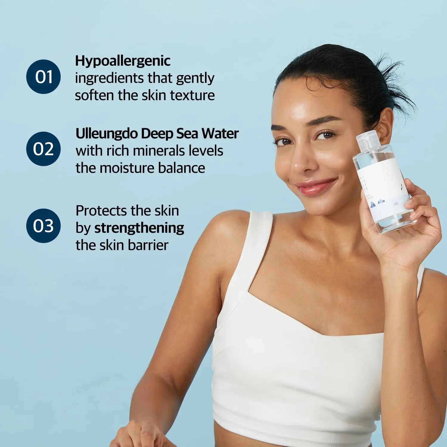 Woman smiling and holding a bottle of ROUND LAB 1025 Dokdo Toner 100ml with text highlighting hypoallergenic ingredients, Ulleungdo Deep Sea Water, and skin barrier protection benefits.