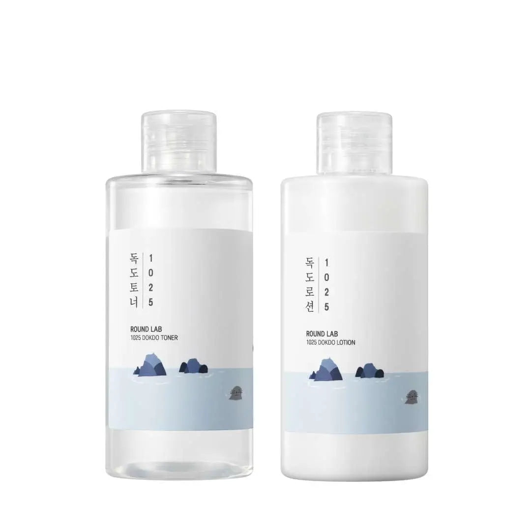 Round LAB 1025 Dokdo Toner 200ml + Dokdo Lotion 200ml set featuring simple, minimalist design bottles with blue and white labeling and an illustration of rocky islands.