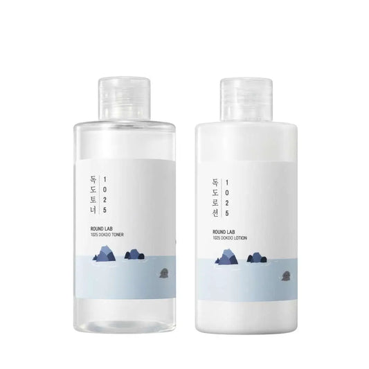 Round LAB 1025 Dokdo Toner 200ml + Dokdo Lotion 200ml set featuring simple, minimalist design bottles with blue and white labeling and an illustration of rocky islands.