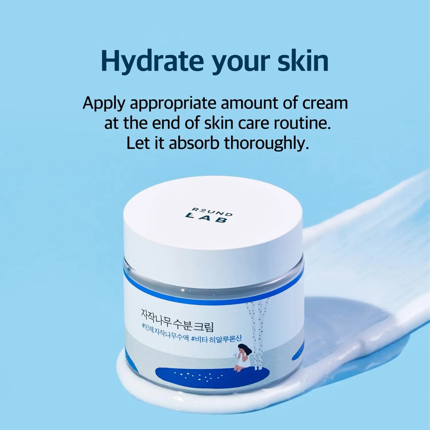 Jar of ROUND LAB Birch Juice Moisturizing Cream 80ml on a blue background with cream spread beside it, accompanied by instructions to hydrate skin by applying cream at the end of skincare routine.