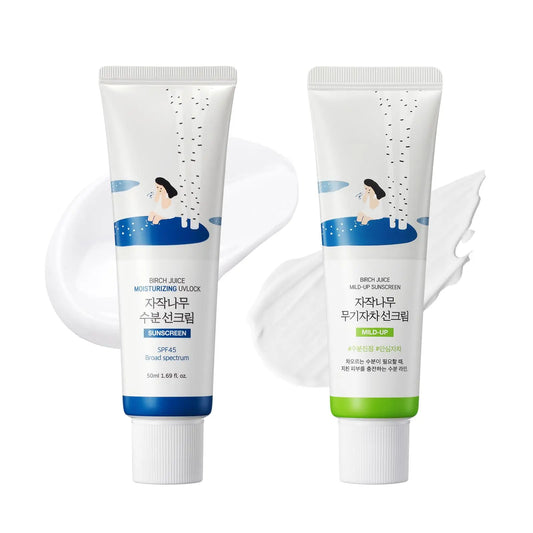 Pair of ROUND LAB Birch Juice Moisturizing Sunscreen 50ml + ROUND LAB Birch Juice Moisturizing Mild Up Sunscreen 50ml tubes with white cream swatches on a white background