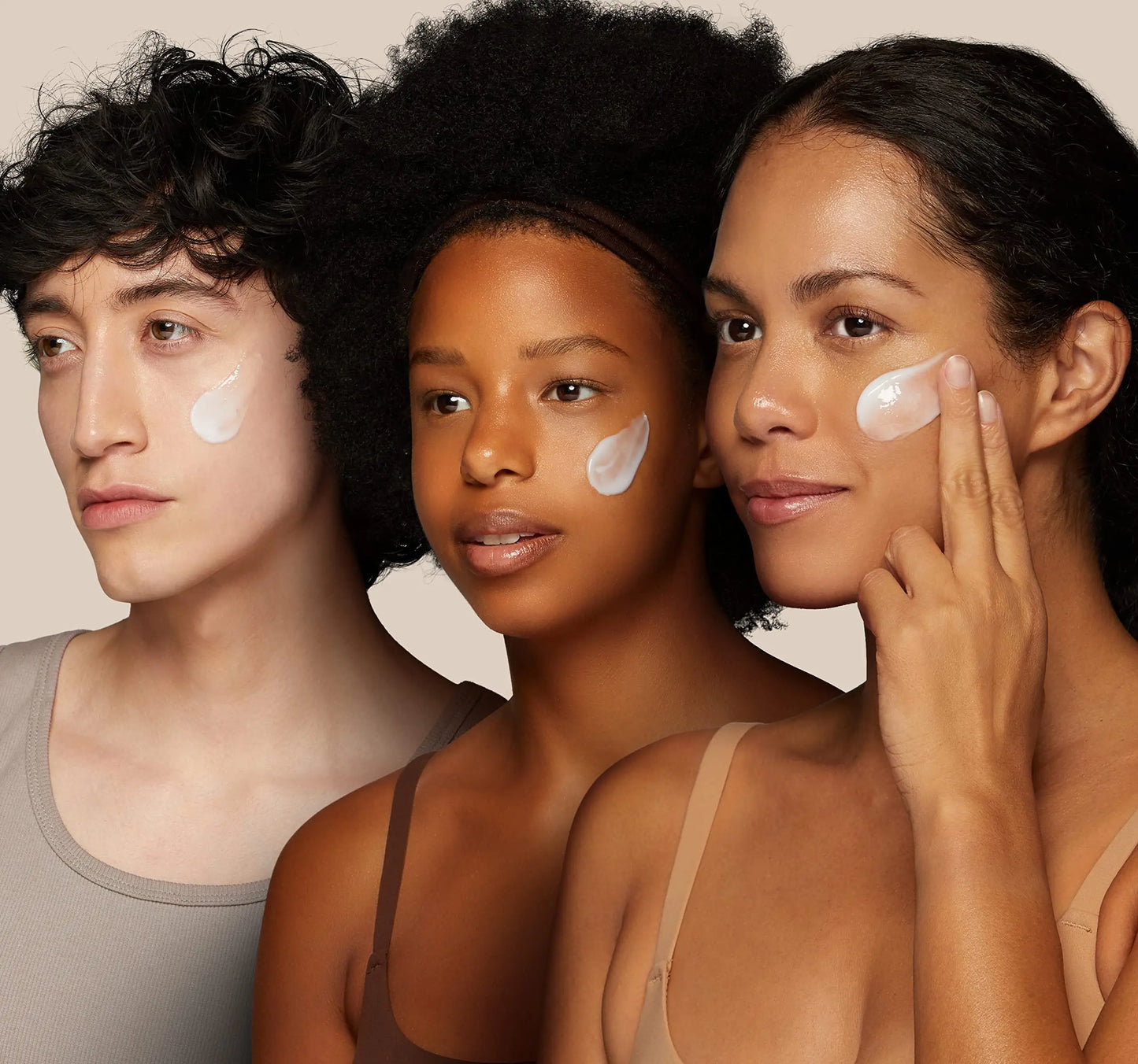Three diverse models applying Skin 1004 Madagascar Centella Soothing Cream 75ml on their cheeks, showcasing smooth, hydrated skin and natural beauty.